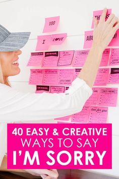 a woman is writing on pink sticky notes with the words 40 easy and creative ways to say i'm sorry