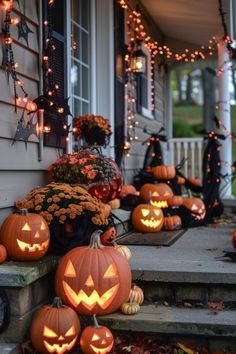 halloween pumpkins on the front steps of a house