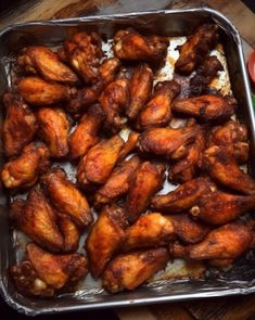 some chicken wings are in a pan on a table