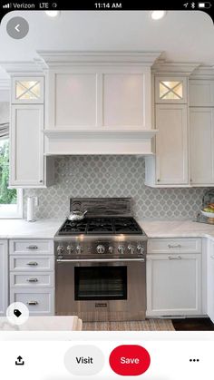 a kitchen with white cabinets and stainless steel stove top oven, which is on sale