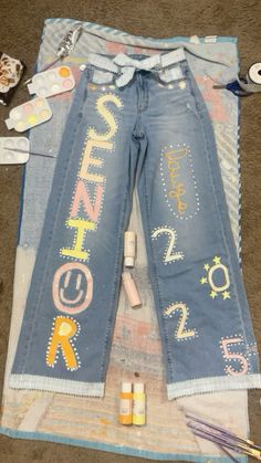 the jeans have been decorated with letters and numbers