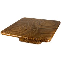 a square wooden table with wavy designs on the top and bottom, against a white background