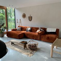 a living room filled with furniture and large windows