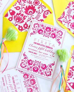 an assortment of candy on top of colorful papers and envelopes for a fiesta themed birthday party