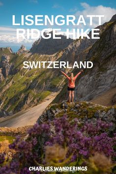 a woman standing on top of a mountain with her arms in the air