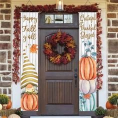 a front door decorated with fall decorations and pumpkins