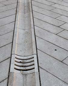 a metal grate sitting on top of a sidewalk