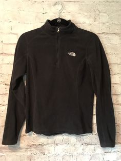 Great for outdoors and layering. The North Face Women's half zip pullover in Black. Zipper Works perfectly. Has a nice tailored fit and is an Extra Small in Women's. Very Soft  100% polyester  Comes from a smoke free environment.  No Rips, holes or stains. In Excellent Used Condition See pictures for details Please message for questions Black The North Face Sweatshirt For Fall, Sporty Black The North Face Sweatshirt, Sporty Black Sweatshirt By The North Face, The North Face Long Sleeve Sweatshirt For Fall, Winter Long Sleeve Sweatshirt By The North Face, The North Face Black Long Sleeve Top, The North Face Long Sleeve Sports Top, Functional Fleece Jacket By The North Face, Functional Long Sleeve Fleece Jacket By The North Face