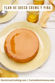 a plate with a cake on it and a spoon next to it that says flan de queso crema y pina