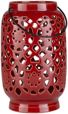 a red candle holder with holes in the middle and a wire hanging from it's side