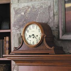 an old clock sitting on top of a mantle