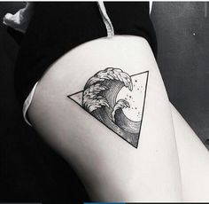 a woman's thigh with a wave and triangle tattoo on her left side ribcage