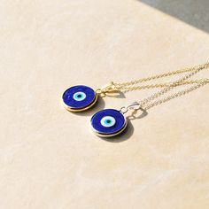 "The Evil Eye symbolizes protection and prosperity. Wear this necklace to deflect negative energy and maintain balance in life. Available in a silver or gold finish. Will not tarnish.  Chain length: 18\" Materials: Handmade Murano Glass with stainless steel 316L frame. (pendant), .925 Sterling Silver, 18k Gold Vermeil Plated (chain)" Spiritual Charm Necklaces With Adjustable Chain, Spiritual Charm Necklace With Adjustable Chain, Spiritual Round Necklace, Cadmium-free, Minimalist Good Luck Necklace With Round Pendant, Evil Eye Medallion Necklace As Gift, Spiritual Cadmium-free Round Pendant Necklace, Stainless Steel Amulet Necklace For Gift, Spiritual Evil Eye Necklace For Everyday, Everyday Spiritual Evil Eye Necklaces