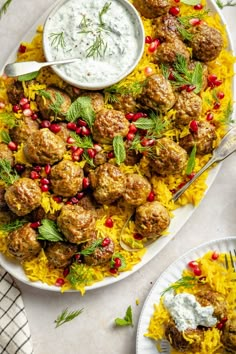 a platter filled with meatballs, rice and garnished with pomegranates