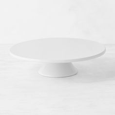 a white cake plate sitting on top of a table