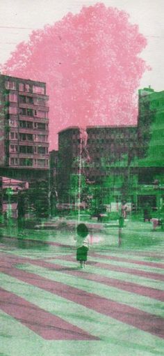 a person with an umbrella walking across a crosswalk in front of some tall buildings