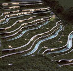 an aerial view of a hillside with many ramps and water slides in the foreground