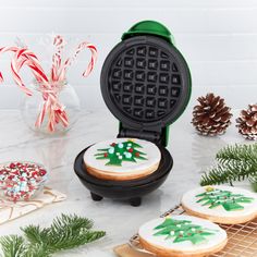 christmas cookies and waffle irons on a table