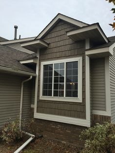 a brown house with white trim and windows