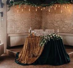 the table is set up with gold sequins and greenery for an elegant look