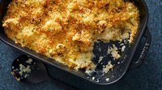 a casserole dish with cheese and parmesan toppings in a black pan