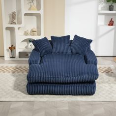 a large blue chair sitting on top of a rug