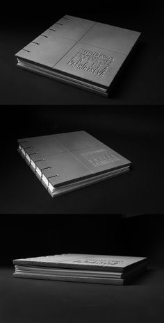 three books are stacked on top of each other in black and white, with the covers folded down