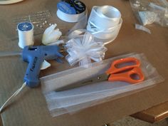 scissors, tape and other crafting supplies on a table