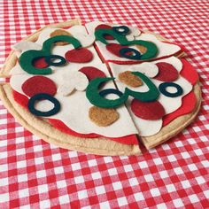 a pizza with numbers on it sitting on top of a red and white tablecloth