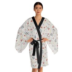 Elegant and versatile, this long sleeve kimono robe features a design of wildflowers. The flowing bell sleeves and figure-flattering shape add a touch of luxury to your loungewear. Perfect for those who enjoy relaxing at home in style or for special occasions like spa days or bridal showers. Product features - Kimono cut with belt tie - 100% polyester for strength and quick drying - Can be worn as a kimono or party dress - Smooth feel and light fabric - Front edge and belt available in black only Care instructions - Do not dry clean - Iron, steam or dry: low heat - Do not tumble dry - Do not bleach - Machine wash: cold (max 30C or 90F) Flowy Wrap Dress, Robe For Women, Spa Days, Long Sleeve Kimono, Cozy Lounge, Belt Tie, Floral Robes, Boho Kimono, Bridal Showers