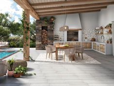 an outdoor kitchen and dining area next to a swimming pool