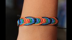 a person wearing a colorful bracelet on their arm