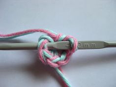 the crochet hook has been hooked up to an object with yarn on it