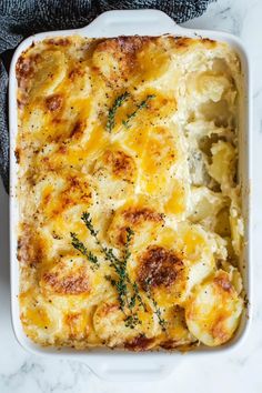 a casserole dish with potatoes and herbs