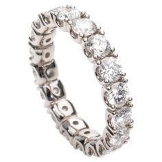 This stunning ring is an Eternity Band, beautifully handcrafted in Italy with a total carat weight of 4.20 carats. The band is made of lustrous 18K white gold, showcasing a series of round diamonds seamlessly set around the entire circumference. The diamonds collectively contribute to the impressive 4.20-carat weight and exhibit a brilliant E-F color, radiating a near-colorless and captivating sparkle. Designed for both elegance and comfort, this Eternity Band features a continuous loop of diamo Eternity Band Ring, Fine Jewels, Eternity Band, Eternity Bands, Stylish Accessories, Eternity Ring, Band Ring, Round Diamonds, Band Rings