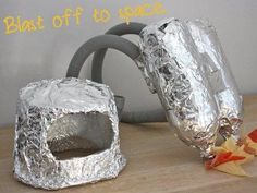 two pieces of tin foil sitting on top of a table next to an orange star