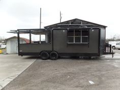 a black trailer parked in front of a building