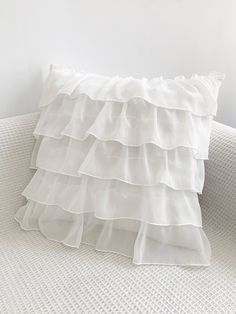 a white pillow with ruffles on it