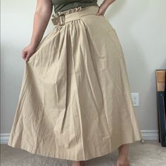 A Classic Belted Skirt With A Fun Asymmetrical Twist. It Has A Roomy Pocket On One Side, And A Gathered Elastic Waistband That Allows It To Fit A Range Of Sizes High Waist Khaki Cotton Skirt, Solid Belted Summer Skirt, Belted Solid Color Skirt For Summer, Solid Colored Summer Skirt With Belt, High Waist Khaki Skirt For Spring, Casual Solid Color Belted Skirt, Casual Asymmetrical Maxi Skirt With Gathered Detail, Casual Asymmetrical Gathered Maxi Skirt, Belted Skirt For Summer