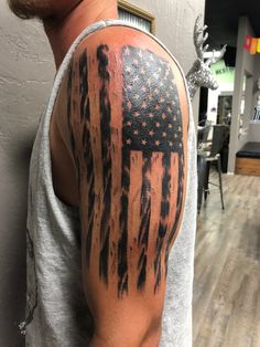 a man with an american flag tattoo on his arm