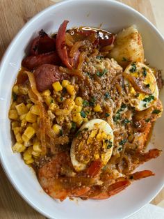 a white bowl filled with food on top of a wooden table