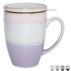 two mugs with different colors and designs on them, one has a spoon in it