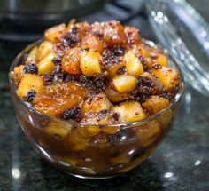 a glass bowl filled with food on top of a counter