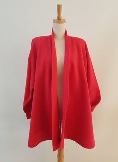 a woman's red jacket on a mannequin headdress with a white background