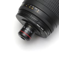 a camera lens sitting on top of a white surface