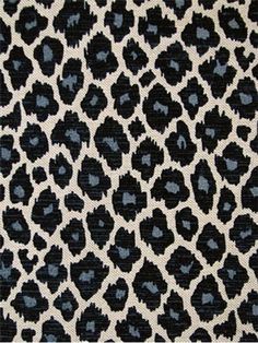 black and white animal print fabric with blue spots on the side, as well as an animal pattern