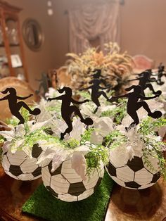 soccer themed centerpieces are displayed on a table