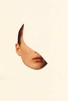 a woman's face is shown through a hole in the paper