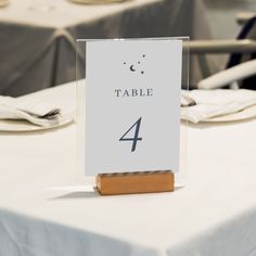 a table number is placed on top of a white table cloth