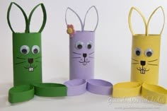 four different colored paper tubes with faces and ears on them, one is made to look like a rabbit